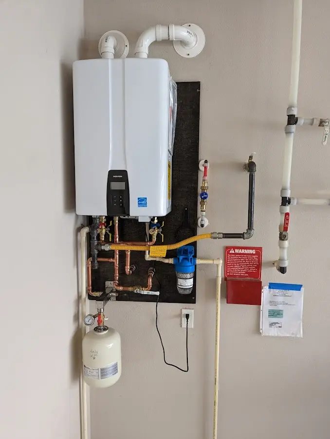 Professional plumber installing copper piping in a Cheektowaga home